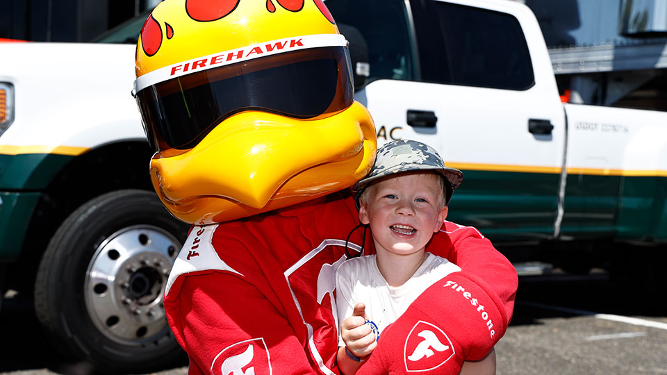 A child poses with Firestone Firehawk