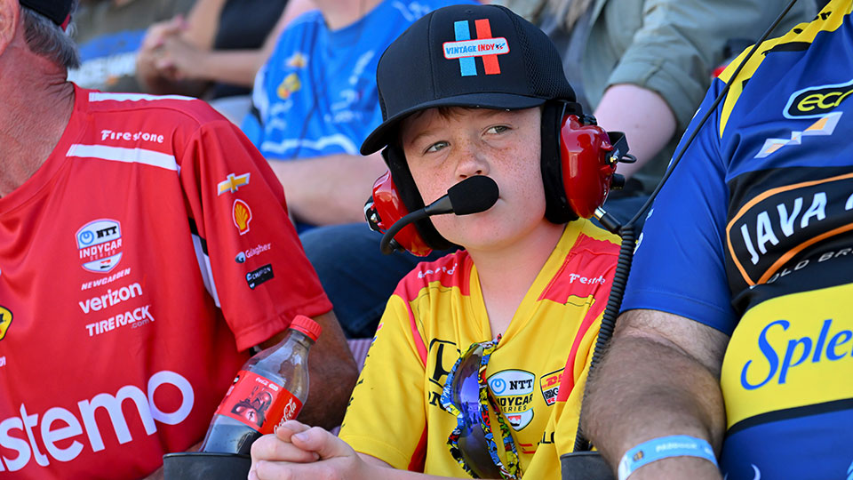 A child watches the on-track action from the grandstands.